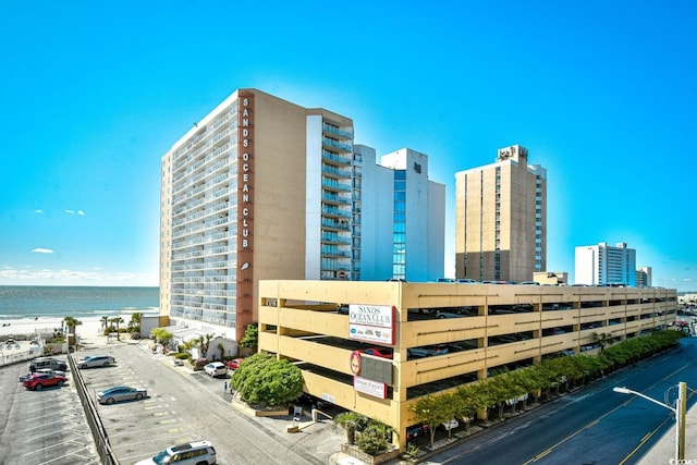 view of building exterior featuring a view of city and a water view