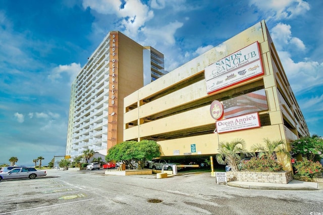 view of building exterior featuring uncovered parking