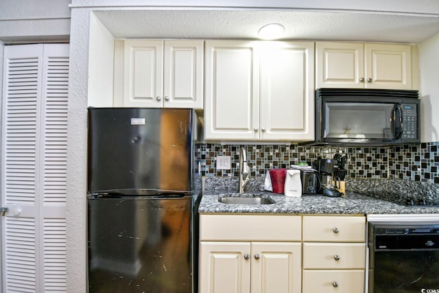 kitchen with cream cabinets, a sink, backsplash, and black appliances