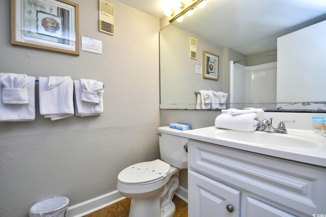 bathroom with baseboards, a shower, toilet, tile patterned flooring, and vanity