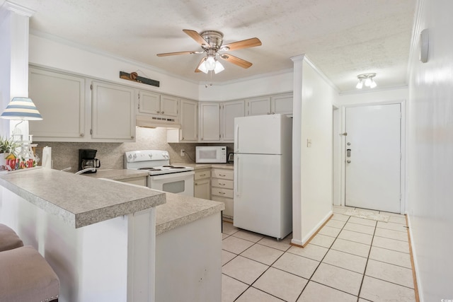 kitchen featuring white appliances, light tile patterned floors, a peninsula, light countertops, and under cabinet range hood