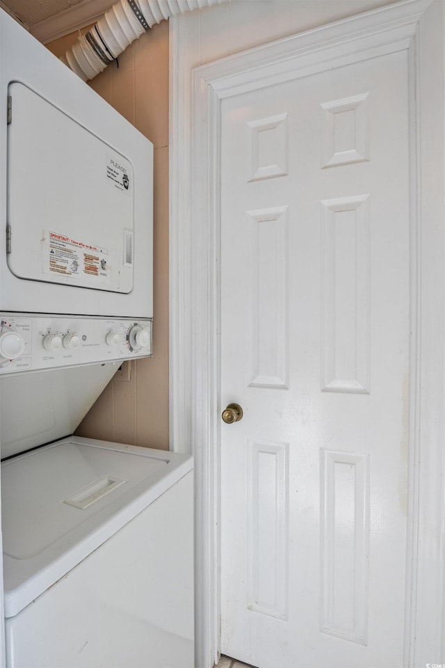 clothes washing area with laundry area and stacked washer / drying machine