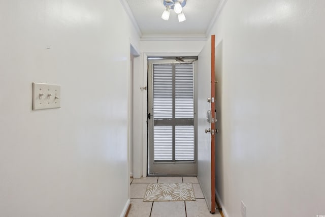 doorway to outside featuring baseboards, ornamental molding, and light tile patterned flooring