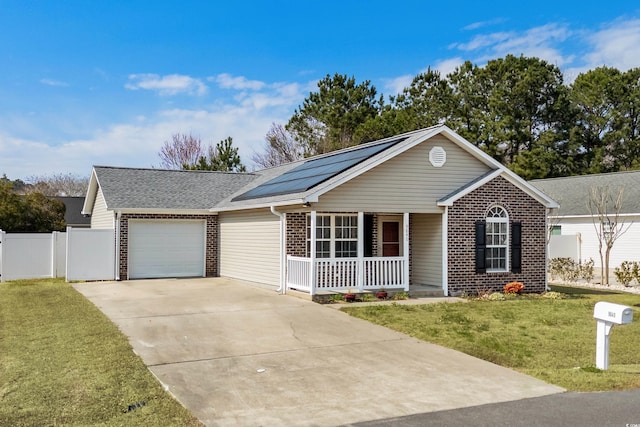 ranch-style house featuring driveway, solar panels, a porch, a front lawn, and brick siding