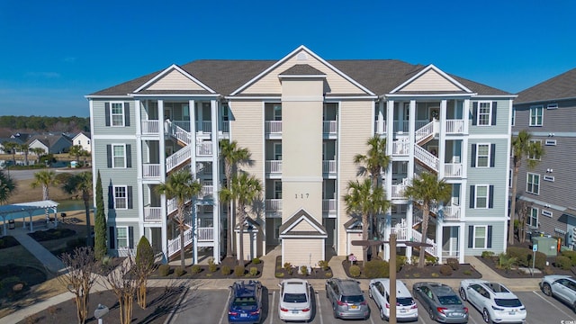 view of building exterior featuring uncovered parking