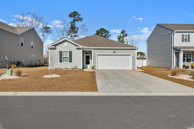 ranch-style house with driveway, an attached garage, central AC, and a shingled roof