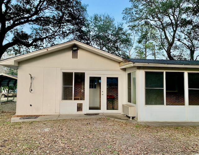 rear view of house featuring french doors and stucco siding