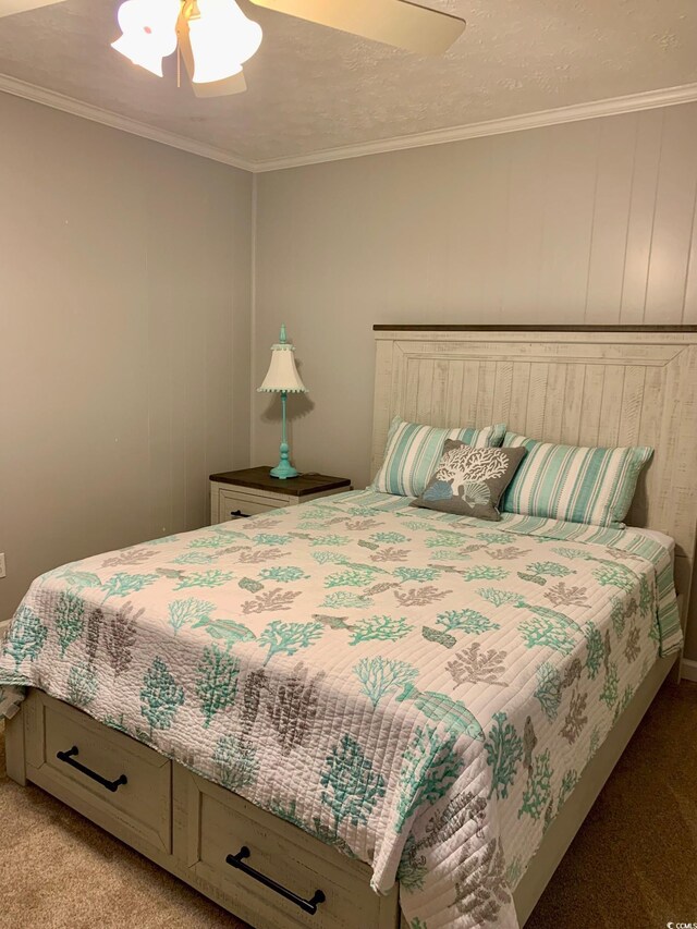 bedroom featuring ornamental molding, light carpet, and a ceiling fan