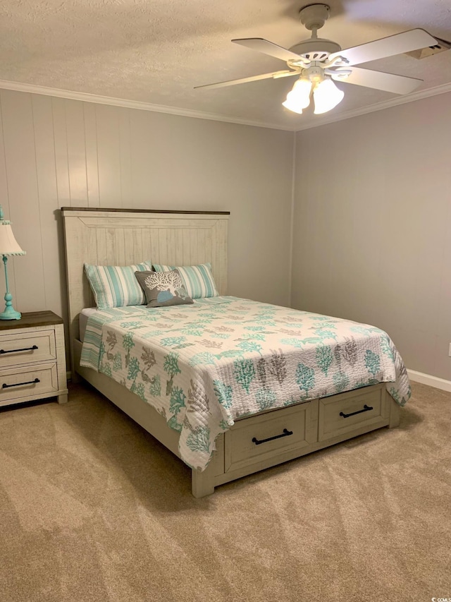 bedroom with light carpet, ceiling fan, a textured ceiling, and crown molding