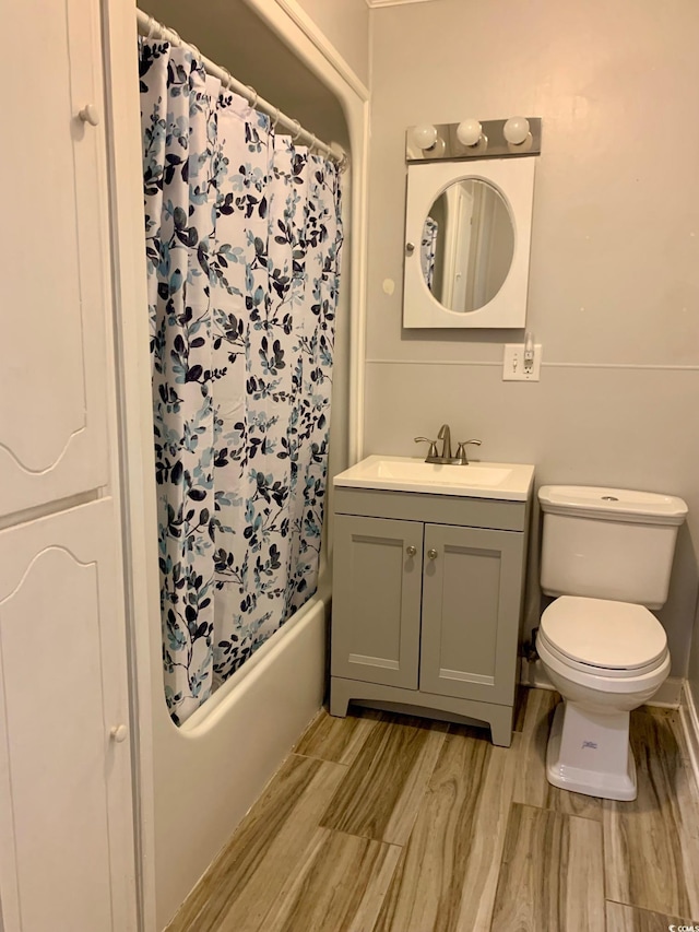 bathroom featuring shower / tub combo, wood finish floors, vanity, and toilet