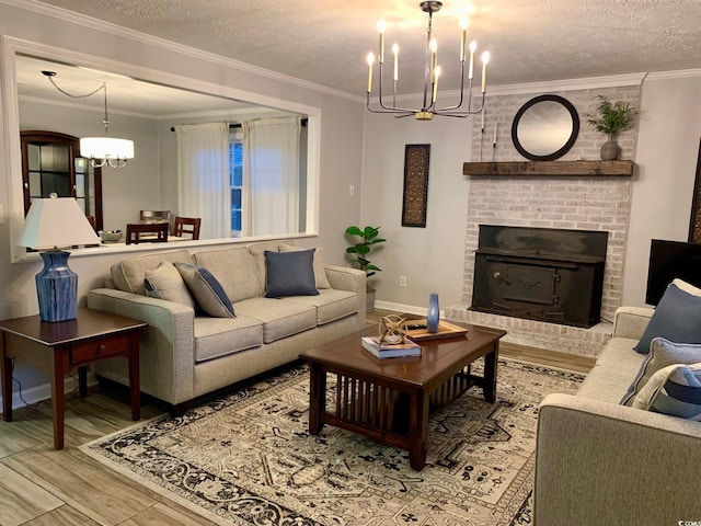 living area featuring light wood-style floors, a textured ceiling, a chandelier, and crown molding