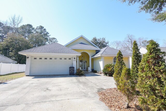 4244 Luck Ave, Little River, SC 29566 - ranch-style house with fence, stucco siding, concrete driveway, and a garage
