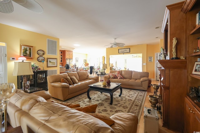 living room with a ceiling fan and visible vents