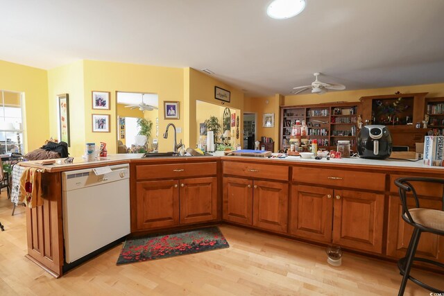 4244 Luck Ave, Little River, SC 29566 - kitchen featuring white dishwasher, ceiling fan, a sink, and light wood-style flooring