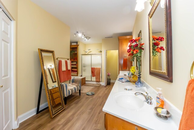 4244 Luck Ave, Little River, SC 29566 - bathroom with wood finished floors, a shower stall, and double vanity