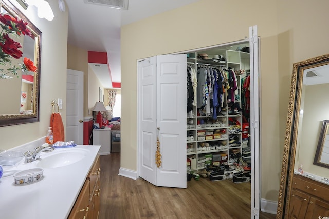 4244 Luck Ave, Little River, SC 29566 - bathroom with wood finished floors, vanity, and a spacious closet