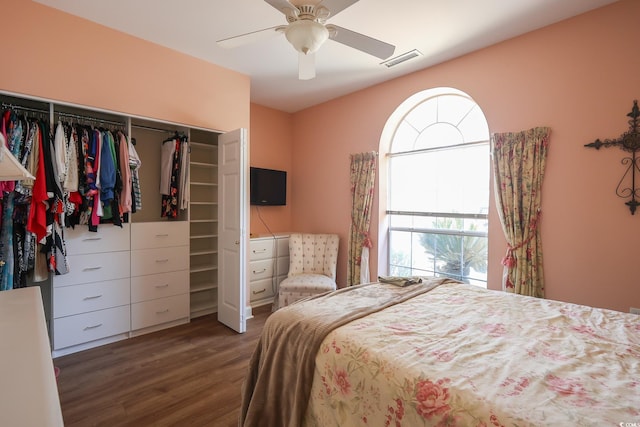 bedroom with ceiling fan, a closet, visible vents, and wood finished floors