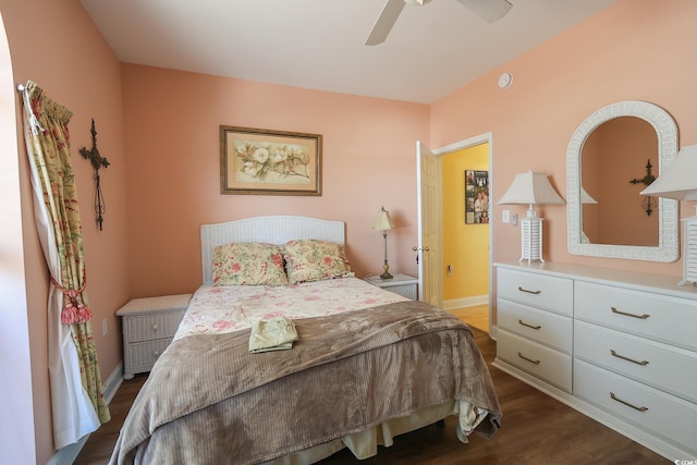 bedroom featuring dark wood-style floors, baseboards, and a ceiling fan