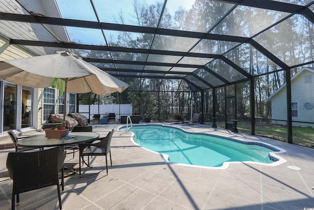 pool featuring a patio area and glass enclosure