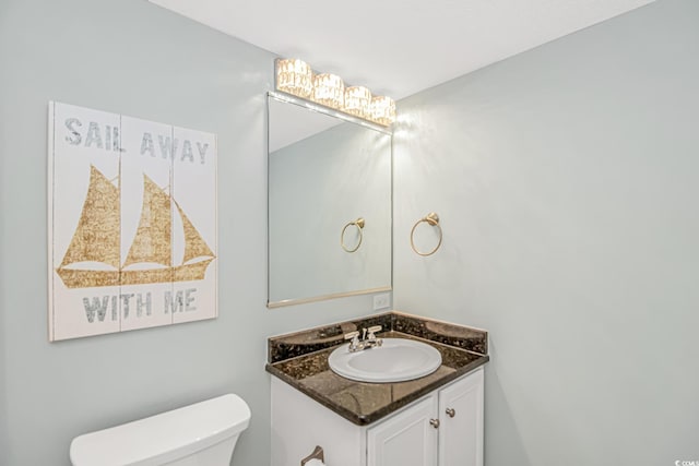 bathroom with toilet and vanity