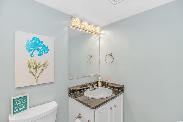 half bath featuring toilet and vanity