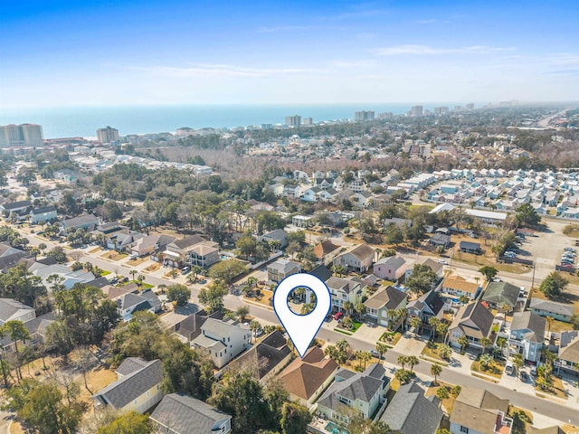 drone / aerial view with a water view and a residential view