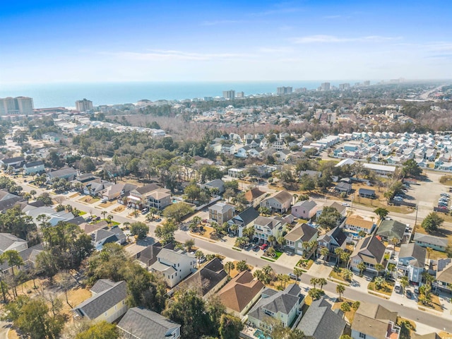 drone / aerial view featuring a water view and a residential view