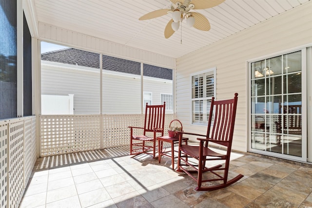 sunroom featuring ceiling fan