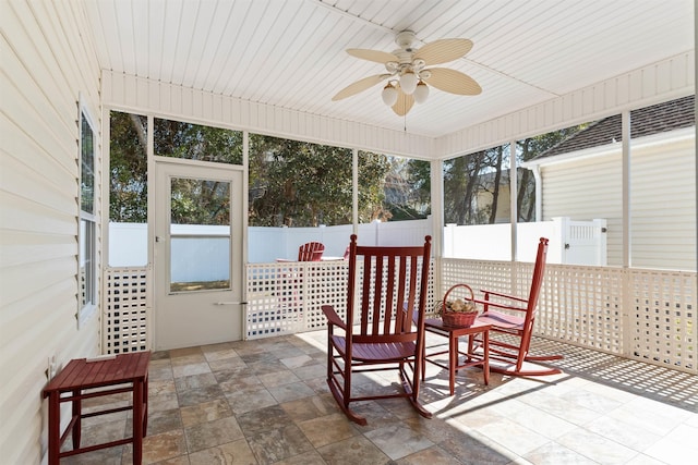 sunroom featuring ceiling fan and plenty of natural light