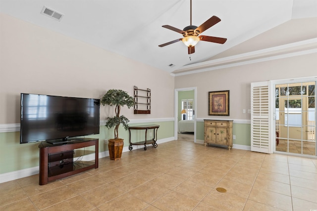 living room featuring lofted ceiling, visible vents, a ceiling fan, light tile patterned flooring, and baseboards