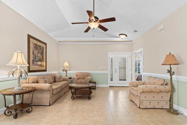 tiled living room with lofted ceiling, visible vents, ceiling fan, and baseboards