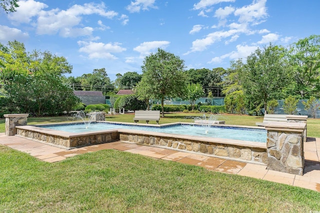 view of pool featuring a yard