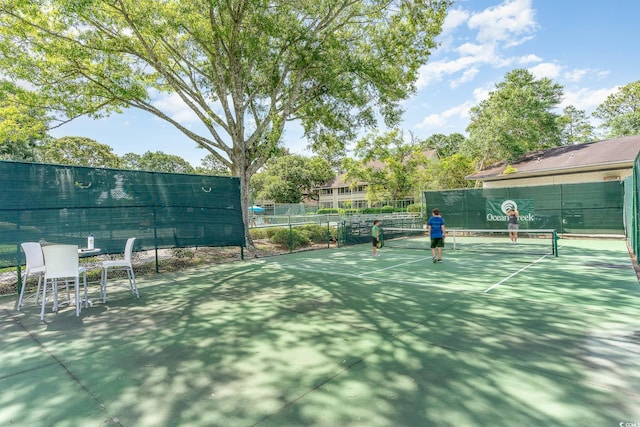 view of tennis court featuring fence