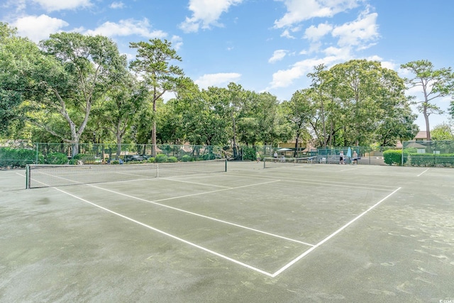 view of sport court featuring fence