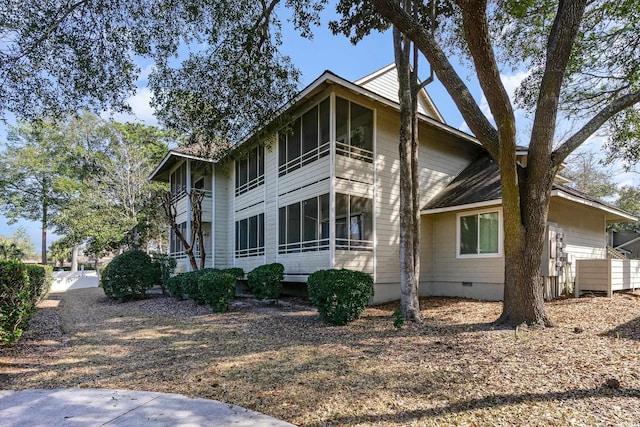 view of property exterior featuring a sunroom and crawl space