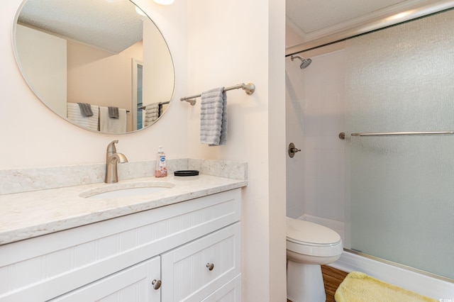 full bathroom with toilet, wood finished floors, vanity, a stall shower, and crown molding