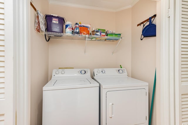 laundry area with laundry area, ornamental molding, and separate washer and dryer