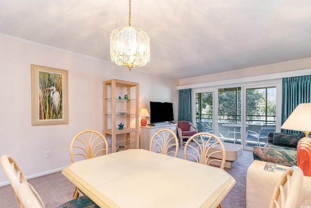 dining space featuring baseboards, ornamental molding, a textured ceiling, carpet flooring, and a chandelier