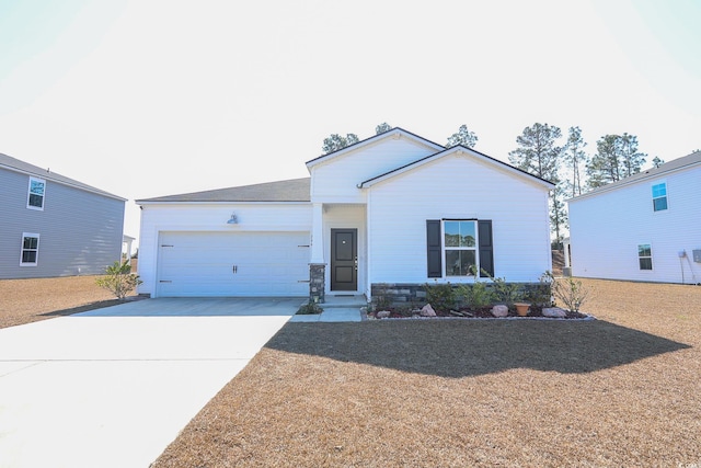 ranch-style home with concrete driveway, an attached garage, and stone siding