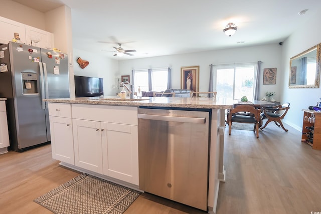 kitchen featuring plenty of natural light, light wood-style floors, and appliances with stainless steel finishes