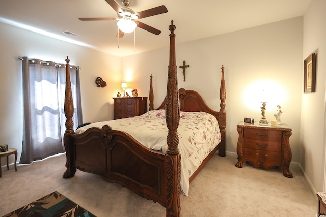 bedroom with baseboards, a ceiling fan, visible vents, and light carpet