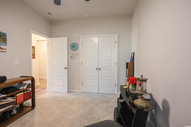 interior space with visible vents, a closet, carpet, baseboards, and ceiling fan