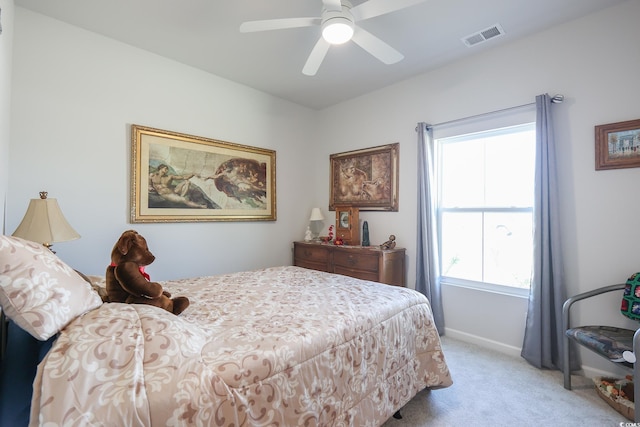 bedroom featuring visible vents, light carpet, baseboards, and a ceiling fan