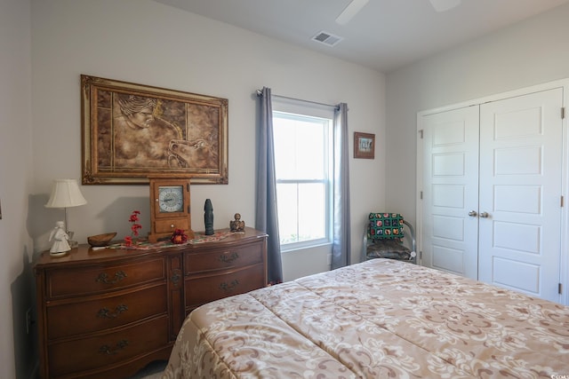 bedroom featuring a closet, visible vents, and ceiling fan