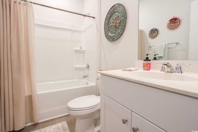 bathroom featuring vanity, toilet, wood finished floors, and shower / bath combo