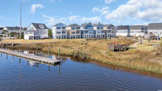 view of dock featuring a water view and a residential view