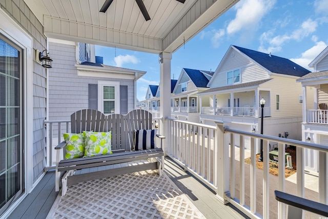 wooden deck featuring a residential view and ceiling fan