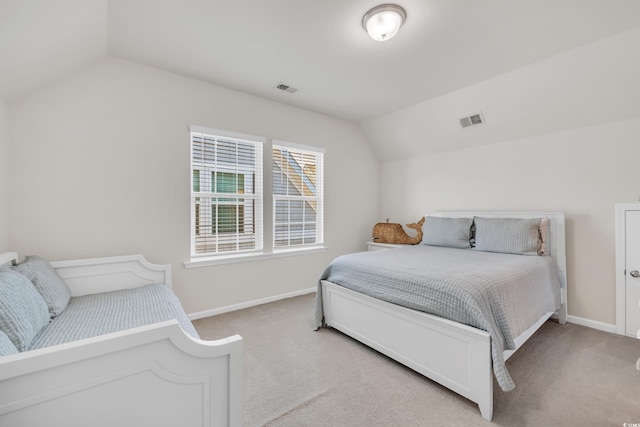 bedroom featuring lofted ceiling, carpet floors, and baseboards