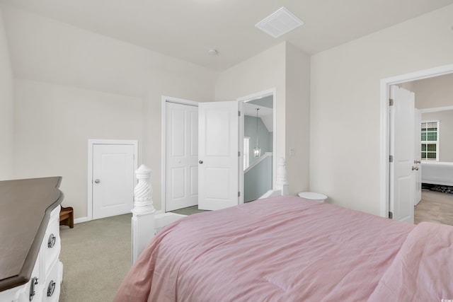 bedroom with light carpet, a closet, visible vents, and baseboards