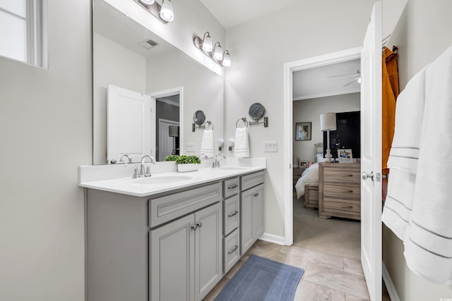 full bath with double vanity, a sink, visible vents, and a ceiling fan